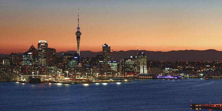 Auckland city skyline and harbour at sunset