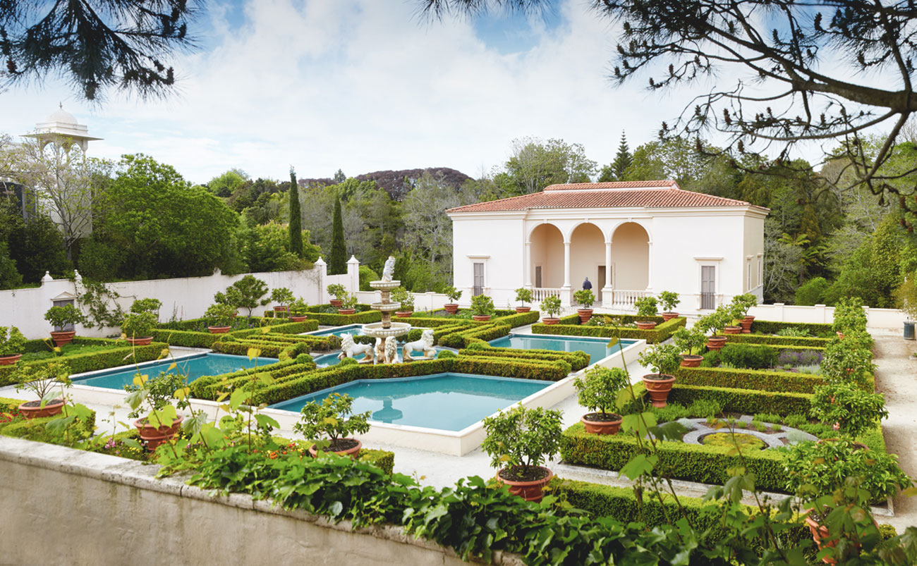 An ornate and immaculately kept garden with box hedges and white walls in the Italian Renaissance Garden at Hamilton Gardens, Waikato, New Zealand